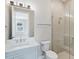 Modern bathroom with a single vanity, toilet and glass shower at 616 Mangrove Point Rd, Siesta Key, FL 34242