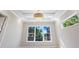 Bedroom with large window, coffered ceiling, and adjacent bathroom at 616 Mangrove Point Rd, Siesta Key, FL 34242