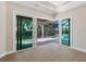 Bright bedroom with sliding glass doors opening to the pool area at 616 Mangrove Point Rd, Siesta Key, FL 34242