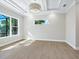 Bright bedroom with large window and coffered ceiling at 616 Mangrove Point Rd, Siesta Key, FL 34242