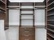 Spacious walk-in closet with ample shelving and drawers at 616 Mangrove Point Rd, Siesta Key, FL 34242