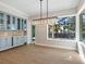 Bright dining room with large window and modern chandelier at 616 Mangrove Point Rd, Siesta Key, FL 34242