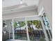 View of backyard oasis with pool and patio through sliding glass doors at 616 Mangrove Point Rd, Siesta Key, FL 34242