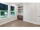 Bright home office features built-in shelves and cabinetry, hardwood floors, and large windows at 616 Mangrove Point Rd, Siesta Key, FL 34242
