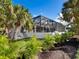 Back exterior view showing a home with tropical landscaping at 616 Mangrove Point Rd, Siesta Key, FL 34242