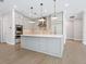 Modern kitchen with stainless steel appliances and light gray cabinets at 616 Mangrove Point Rd, Siesta Key, FL 34242