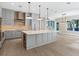 Spacious kitchen with island, stainless steel appliances, and light gray cabinets at 616 Mangrove Point Rd, Siesta Key, FL 34242
