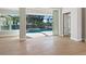 Open living area with sliding doors leading to the pool at 616 Mangrove Point Rd, Siesta Key, FL 34242