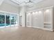 Open living room with built-in shelving and access to the pool at 616 Mangrove Point Rd, Siesta Key, FL 34242