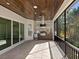 Outdoor kitchen with stainless steel appliances and wood ceiling at 616 Mangrove Point Rd, Siesta Key, FL 34242