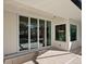Sliding glass doors open to a relaxing pool area with patio at 616 Mangrove Point Rd, Siesta Key, FL 34242