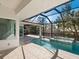 Relaxing pool and spa with screened enclosure and outdoor kitchen at 616 Mangrove Point Rd, Siesta Key, FL 34242