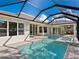 Luxury pool and spa with screened enclosure and outdoor kitchen at 616 Mangrove Point Rd, Siesta Key, FL 34242