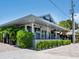 Modern restaurant building with gray facade and manicured hedges at 616 Mangrove Point Rd, Siesta Key, FL 34242