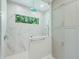 Walk-in shower with marble tile and glass enclosure at 616 Mangrove Point Rd, Siesta Key, FL 34242