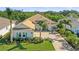 Luxury home with a tile roof, light-colored exterior, and lush landscaping at 7168 Ryedale Ct, Sarasota, FL 34241