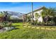Landscaped backyard with a covered patio, lush foliage, and stone pathway at 7168 Ryedale Ct, Sarasota, FL 34241