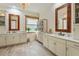 Elegant bathroom with double vanity, large mirror, and walk-in shower at 7168 Ryedale Ct, Sarasota, FL 34241