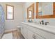 Elegant bathroom featuring a double vanity, white cabinets, and a tiled shower at 7168 Ryedale Ct, Sarasota, FL 34241