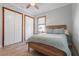Spacious bedroom with a queen-size bed, white closet doors, and wood floors at 7168 Ryedale Ct, Sarasota, FL 34241