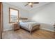 Bright bedroom with a queen bed, wood floors, and a rustic nightstand at 7168 Ryedale Ct, Sarasota, FL 34241