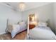 Charming bedroom with two twin beds, light wood floors, and a tranquil atmosphere at 7168 Ryedale Ct, Sarasota, FL 34241