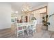 Bright dining room with white table and chairs, chandelier, and hardwood floors at 7168 Ryedale Ct, Sarasota, FL 34241