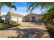 Spacious home with a three-car garage and palm trees at 7168 Ryedale Ct, Sarasota, FL 34241
