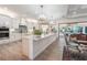 Spacious kitchen with island, stainless steel appliances, and light wood cabinets at 7168 Ryedale Ct, Sarasota, FL 34241