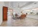 Bright kitchen boasts a large island, white cabinetry, and a light blue backsplash at 7168 Ryedale Ct, Sarasota, FL 34241
