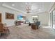 Spacious living room with light blue sofa, wood floors, and large windows at 7168 Ryedale Ct, Sarasota, FL 34241