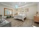 Peaceful main bedroom with a canopy bed and light wood floors at 7168 Ryedale Ct, Sarasota, FL 34241