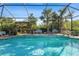 Inviting screened pool with water features and lush landscaping at 7168 Ryedale Ct, Sarasota, FL 34241