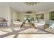 Covered patio with wicker furniture and views of the pool and surrounding landscape at 7168 Ryedale Ct, Sarasota, FL 34241