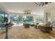 Relaxing pool patio with wicker furniture and ceiling fans, perfect for outdoor entertaining at 7168 Ryedale Ct, Sarasota, FL 34241
