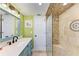 Spa-like bathroom with walk-in shower and pebble tile at 9363 Steubenville Ave, Englewood, FL 34224