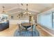 Bright dining room with a round table, chandelier, and large windows at 9363 Steubenville Ave, Englewood, FL 34224