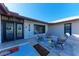 Relaxing front porch with colorful floor tiles and gray chairs at 9363 Steubenville Ave, Englewood, FL 34224
