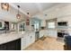 Modern kitchen with white shaker cabinets, granite counters, and stainless steel appliances at 9363 Steubenville Ave, Englewood, FL 34224