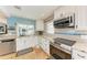 Modern kitchen with stainless steel appliances and granite countertops at 9363 Steubenville Ave, Englewood, FL 34224