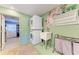 Convenient laundry room with stackable washer/dryer and utility sink at 9363 Steubenville Ave, Englewood, FL 34224