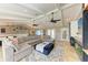 Open-concept living room with sectional sofa, dining area, and high ceilings at 9363 Steubenville Ave, Englewood, FL 34224