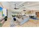 Open living space with sectional sofa, high ceilings, and access to kitchen at 9363 Steubenville Ave, Englewood, FL 34224
