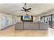 Open living area with sectional sofa, exposed beams, and a view of the pool at 9363 Steubenville Ave, Englewood, FL 34224