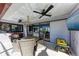 Covered patio with seating area and a large TV at 9363 Steubenville Ave, Englewood, FL 34224