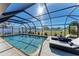 Inviting screened pool with lounge chairs and large backyard at 9363 Steubenville Ave, Englewood, FL 34224