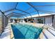 Large screened pool with patio and view of the house at 9363 Steubenville Ave, Englewood, FL 34224
