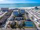 Aerial view of beachfront property with tennis courts and swimming pool at 1080 W Peppertree Ln # 506A, Sarasota, FL 34242