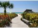 Private beach access with walkway and seating at 1080 W Peppertree Ln # 506A, Sarasota, FL 34242