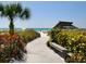 Convenient beach access path with scenic walkway and seating at 1080 W Peppertree Ln # 506A, Sarasota, FL 34242